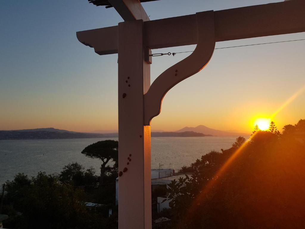 a sunset seen from a building with a view of the ocean at b&b Dea Fortuna in Bacoli
