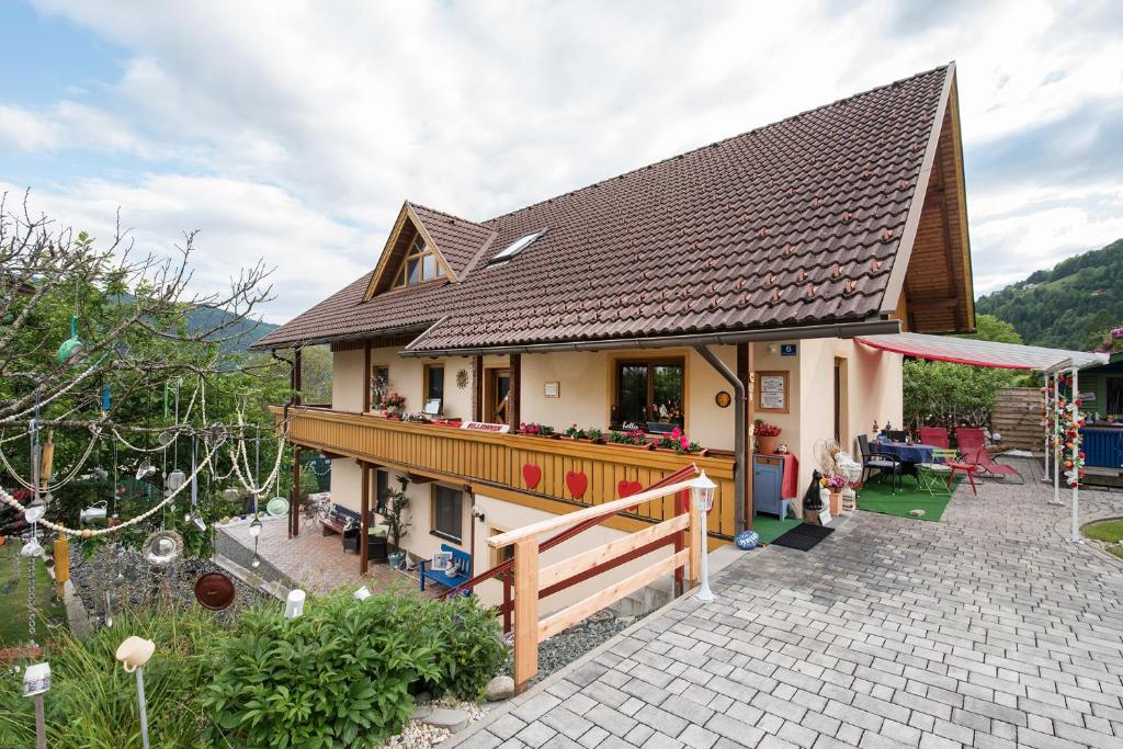 a house with a roof with a patio at Landhaus Dora in Bodensdorf