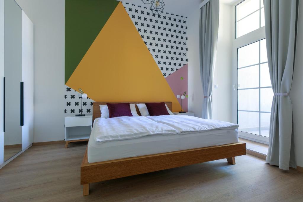 Postel nebo postele na pokoji v ubytování Avantgarde apartments
