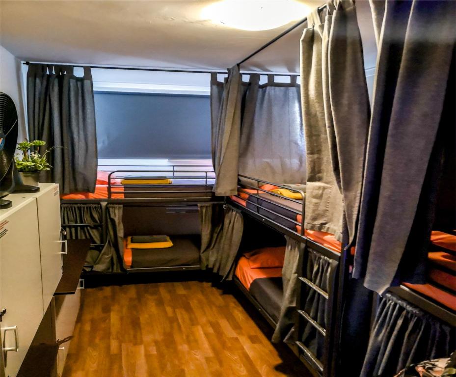 a group of bunk beds in a room with wood floors at Live Lisboa Hostel in Lisbon
