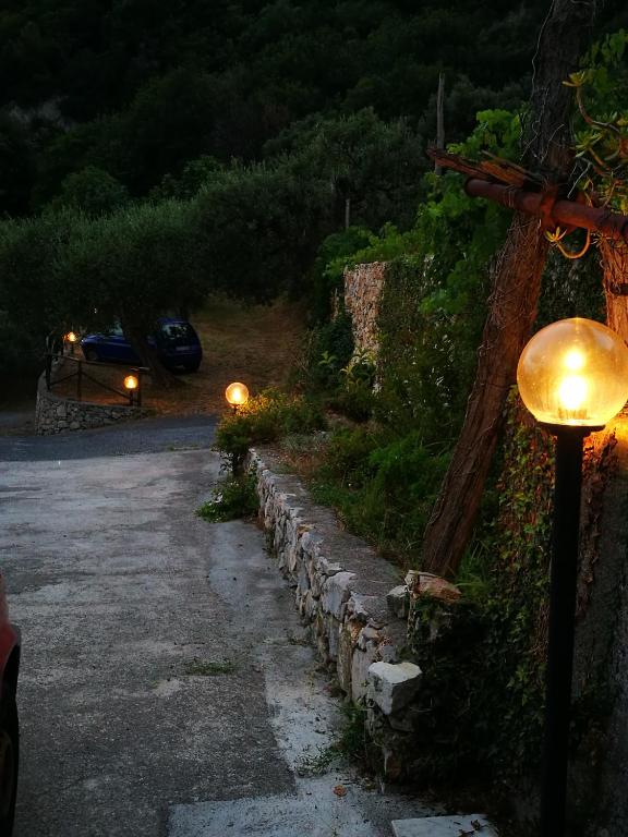 a street light next to a stone wall at night at Gli ulivi della Monda in Finale Ligure