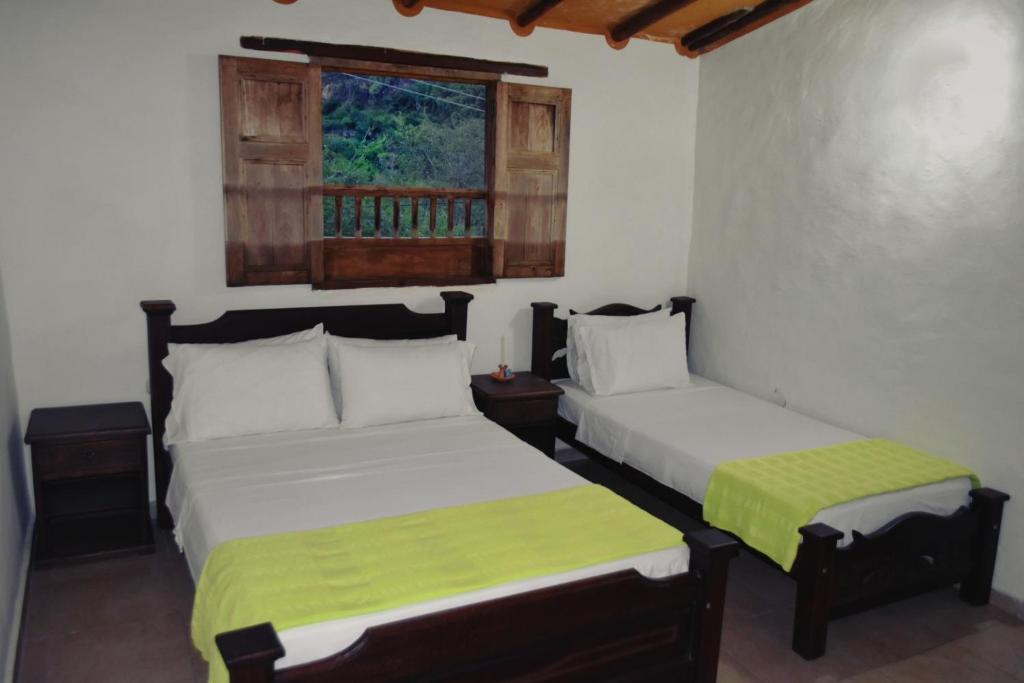 Postel nebo postele na pokoji v ubytování Posada Villa Paula
