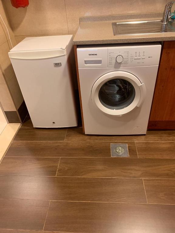 a washing machine in a kitchen next to a sink at Paragon Hotel Apartments in Abu Dhabi