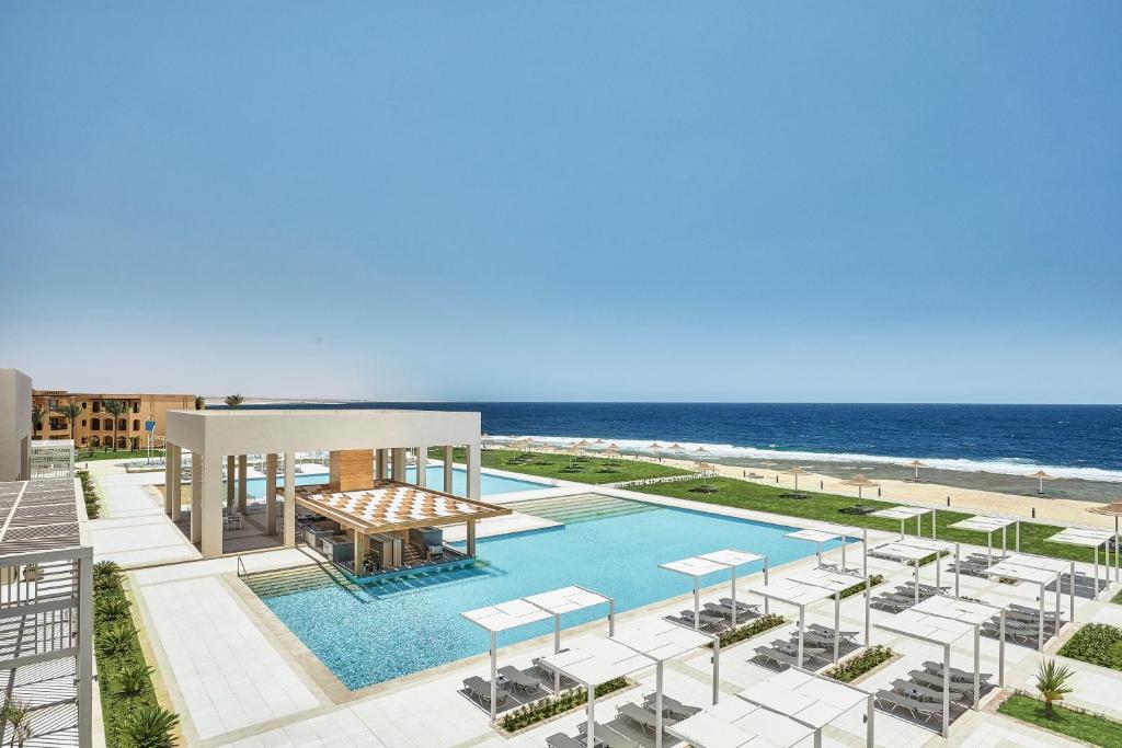 an aerial view of a pool with the beach at Jaz Maraya Resort in Coraya Bay