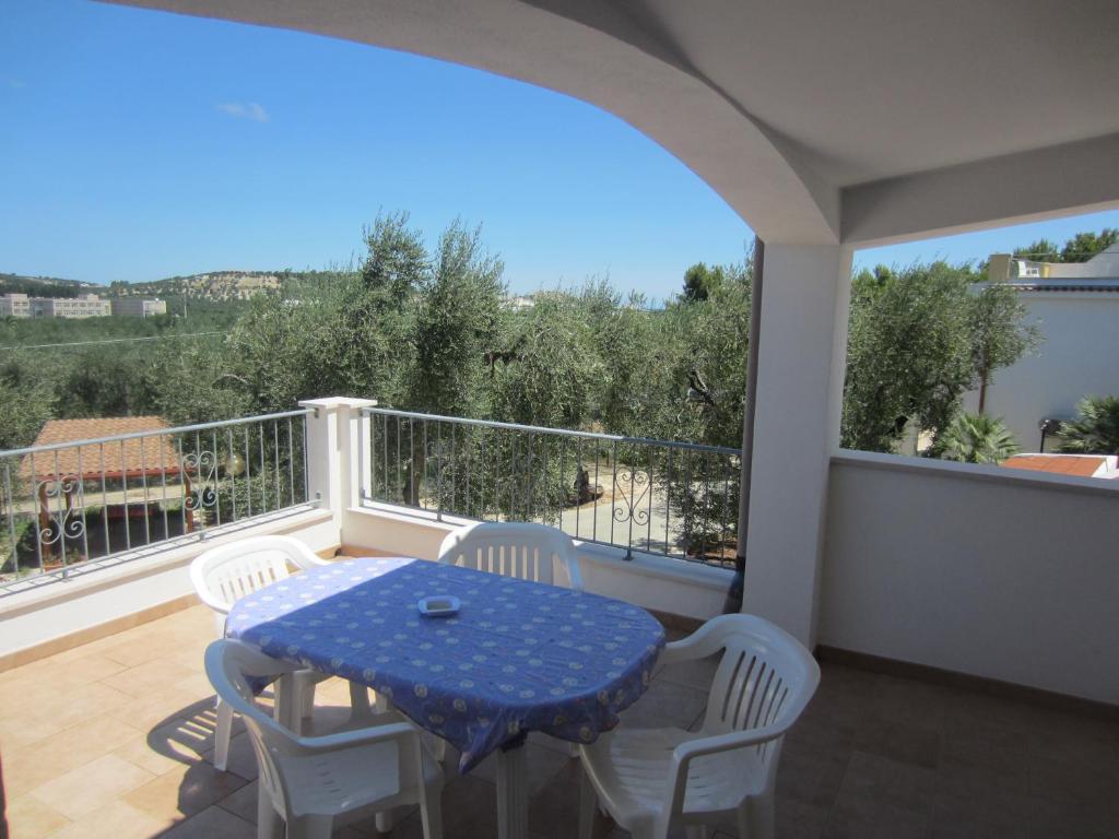 a table and chairs on a balcony with a view at Case vacanze Villa Elisa in Vieste