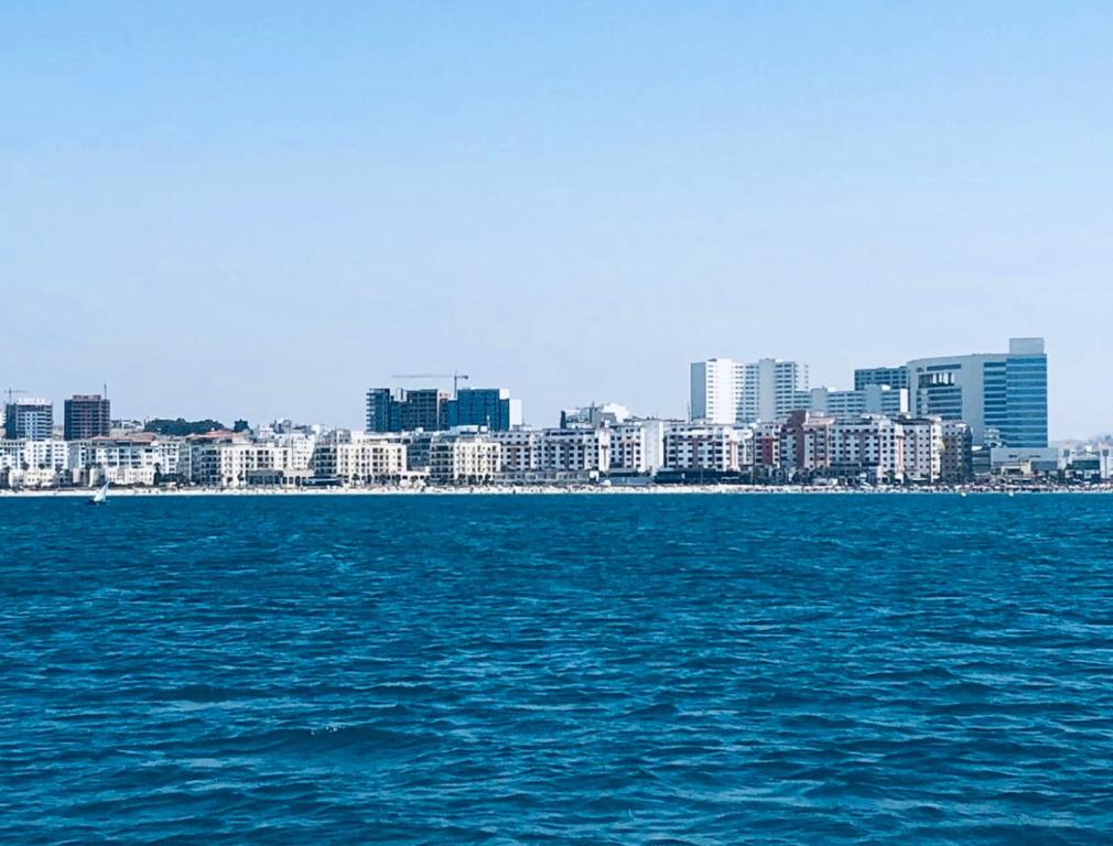 a view of a city from the water at Haut standing beach apartment in Tangier