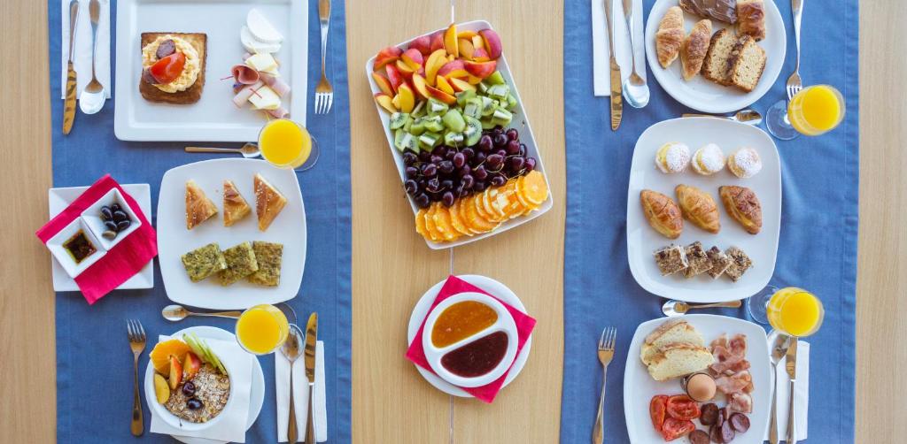 a table with plates of food on it at Spetses Hotel in Spetses