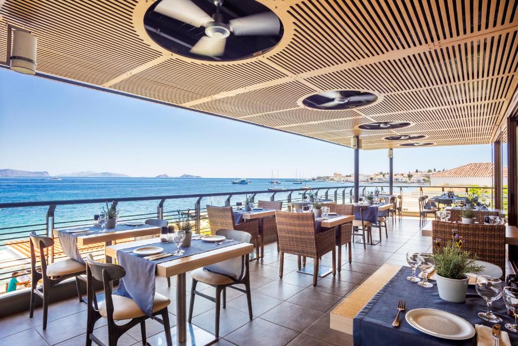 a restaurant with a view of the ocean at Spetses Hotel in Spetses
