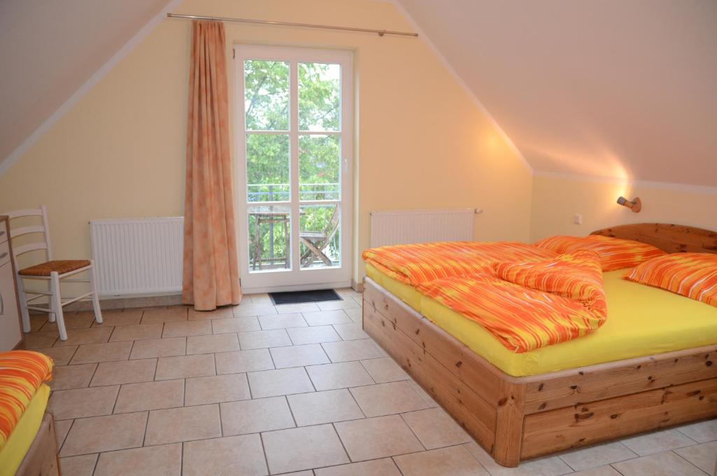 a bedroom with two beds and a window at Ferienresidenz Am Strom in Warnemünde