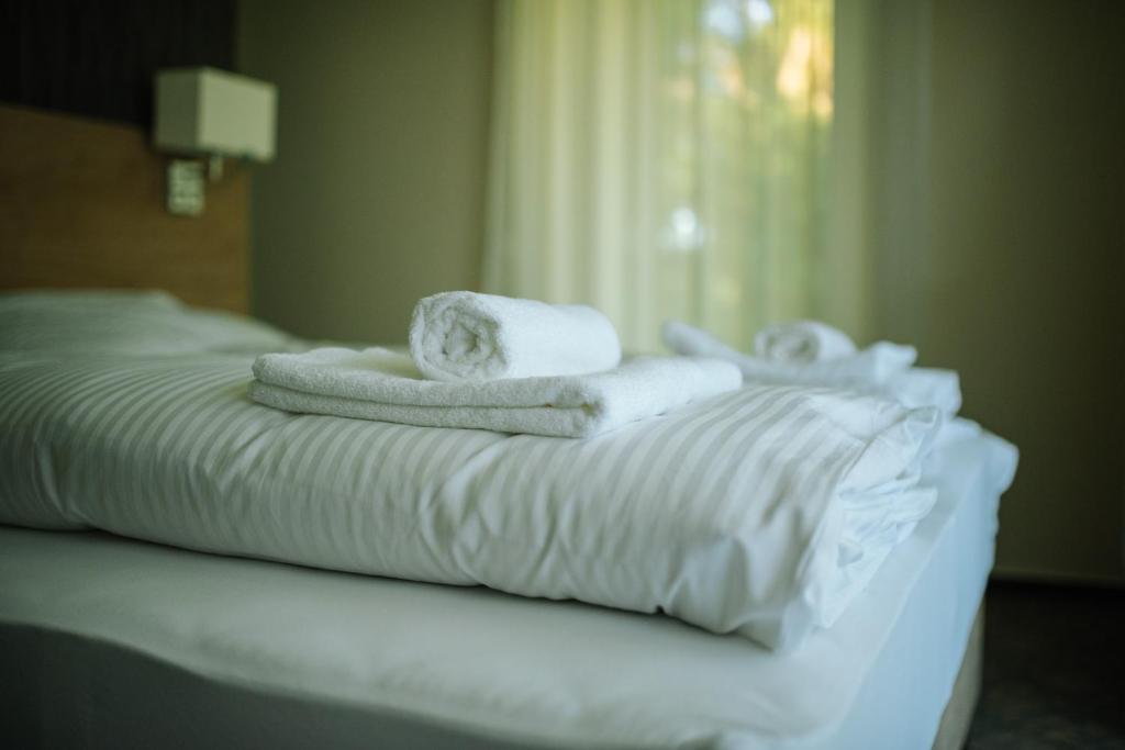 Postel nebo postele na pokoji v ubytování Easy Suites Hévíz