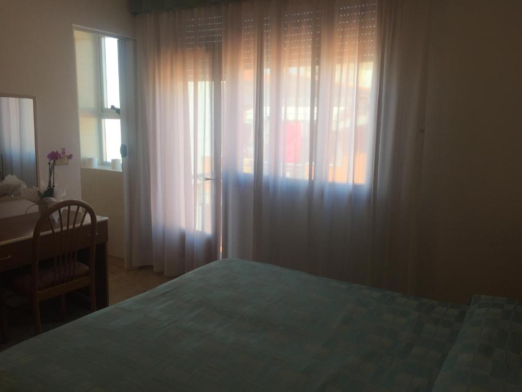 Postel nebo postele na pokoji v ubytování Hotel Margherita