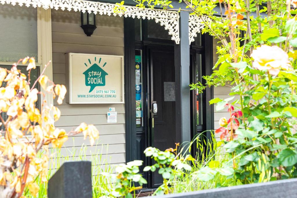 a sign on the front door of a house at Stay Social in Bendigo