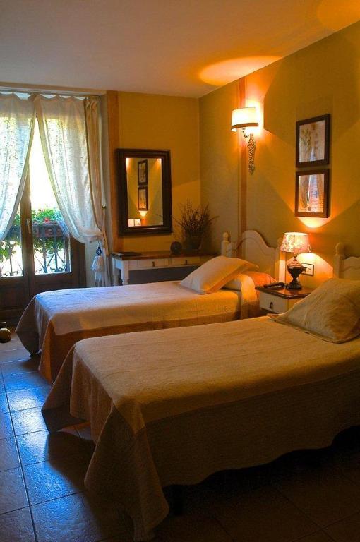 Postel nebo postele na pokoji v ubytování Hotel Casa Frauca