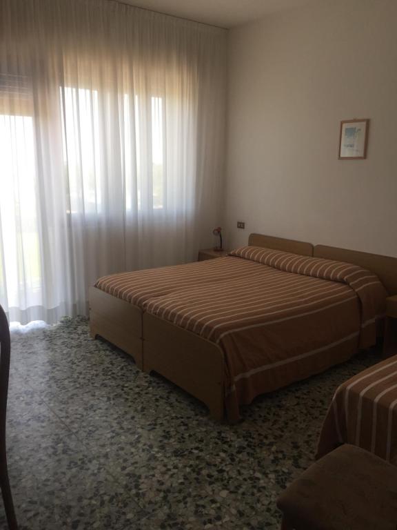 Postel nebo postele na pokoji v ubytování Hotel Margherita