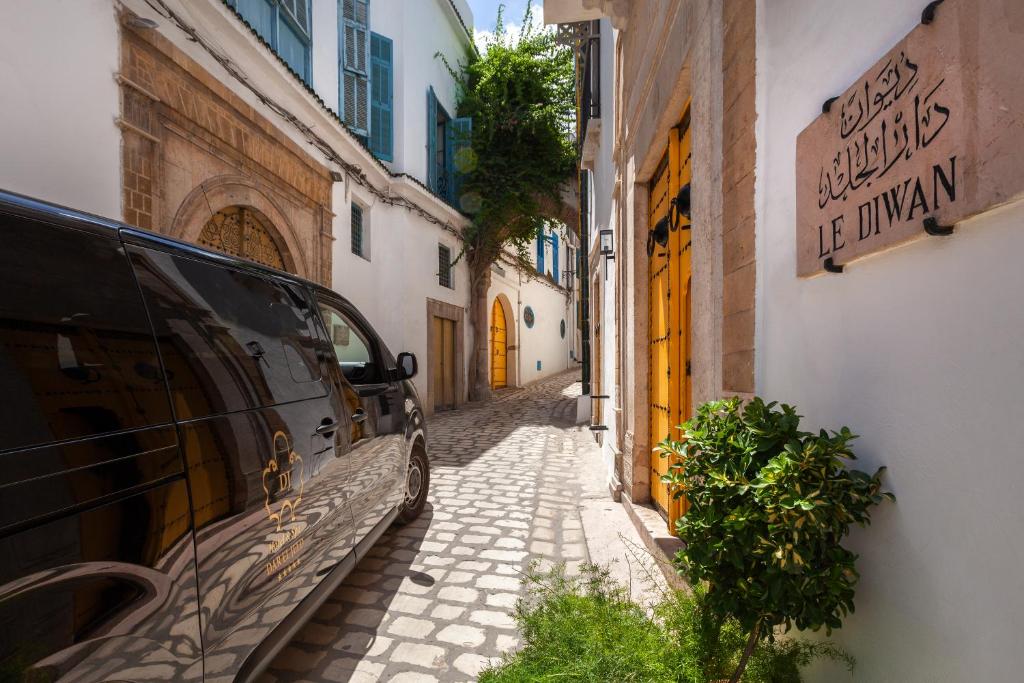 a street with a car parked on the side of a building at Dar El Jeld Hotel and Spa in Tunis