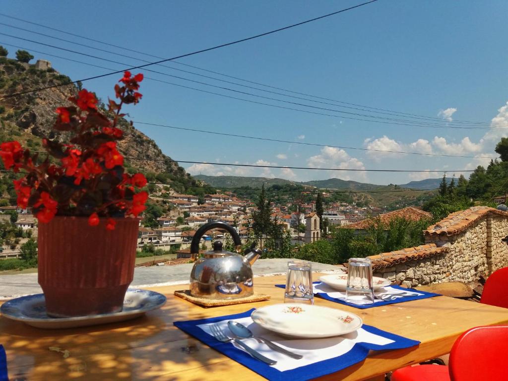 a table with a tea pot on a table with a view at Teo’s Guest House in Berat