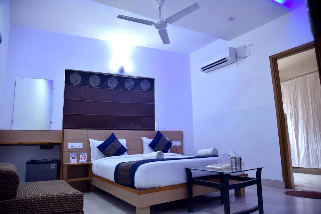 a bedroom with a bed and a ceiling fan at DIVUD ECOM HOTEL- 30 Meters From Golden Temple in Amritsar