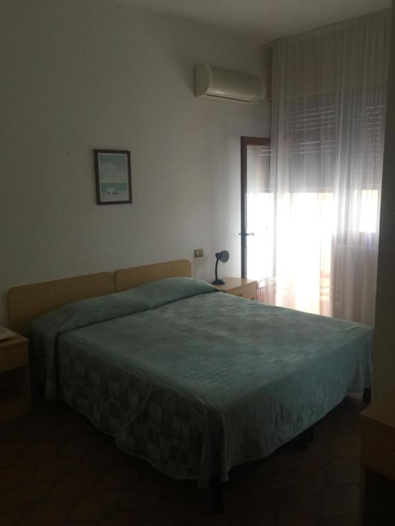 Postel nebo postele na pokoji v ubytování Hotel Margherita