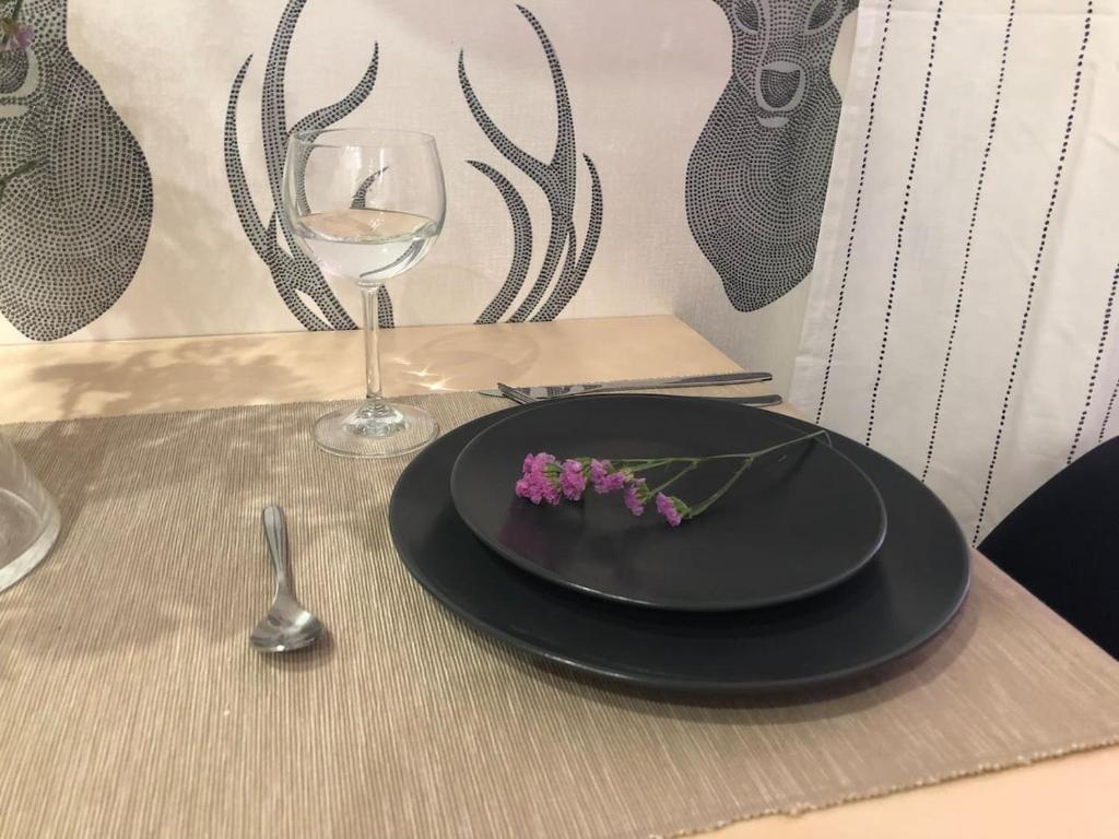 a table with a black plate and a glass of wine at Studio @ Market Square Gliwice in Gliwice