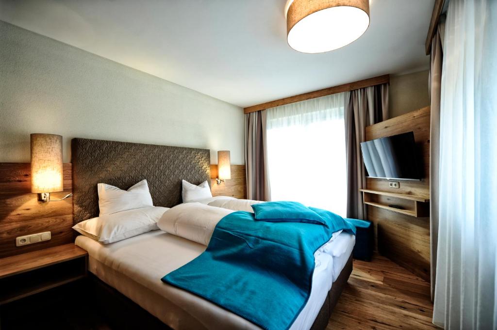 Postel nebo postele na pokoji v ubytování Hotel Dorfstadl