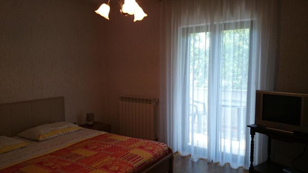 Postel nebo postele na pokoji v ubytování Apartman Dino