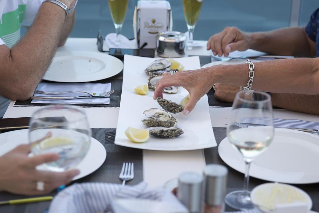 a group of people sitting at a table with wine glasses at Ocean Lounge in Altea