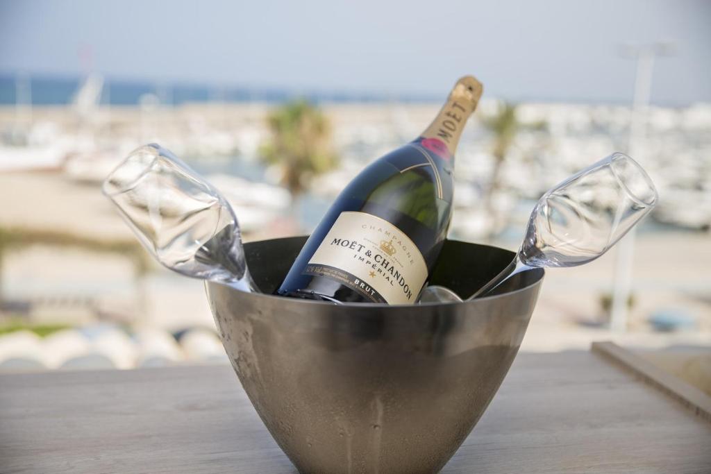 a bucket filled with wine bottles and glasses on a table at Ocean Lounge in Altea