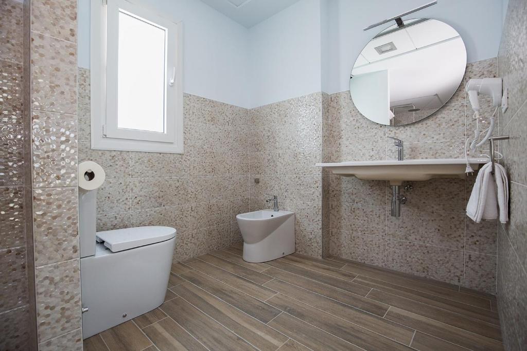a bathroom with a toilet and a sink and a mirror at Ocean Lounge in Altea