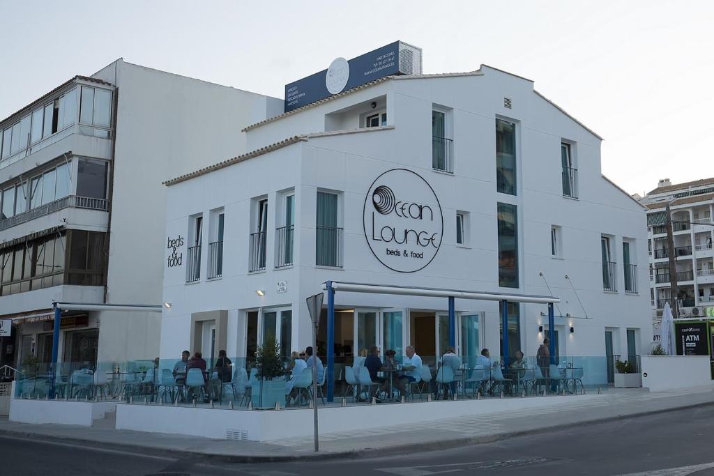 a white building with people sitting outside of it at Ocean Lounge in Altea
