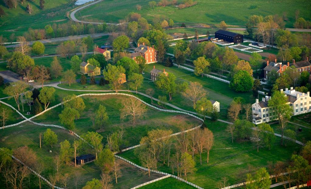 an aerial view of a park with buildings and trees at Shaker Village of Pleasant Hill in Harrodsburg