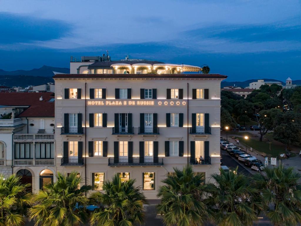 a large white building with lights on top of it at Hotel Plaza e de Russie - Relais & Châteaux in Viareggio