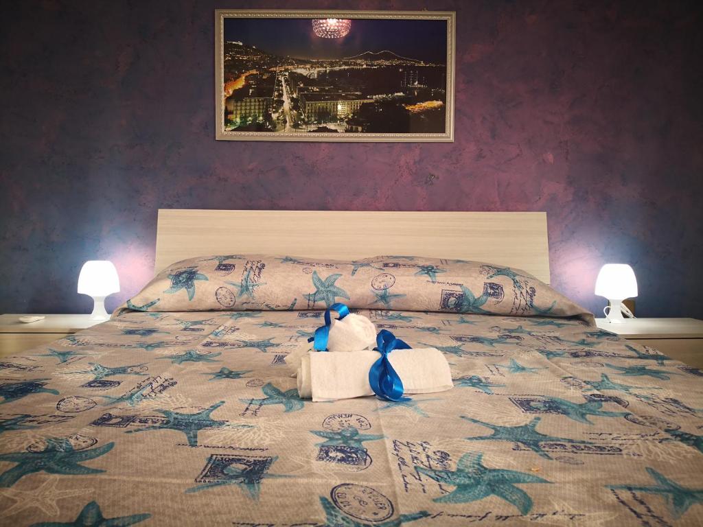 um ursinho de peluche sentado em cima de uma cama em House of Flowers em Pompeia