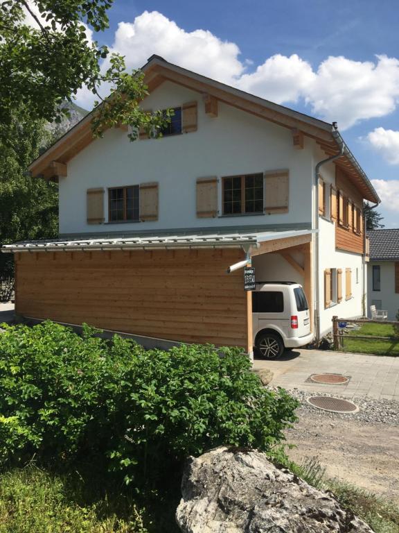 a house with a car parked in front of it at Casacanols in Valbella