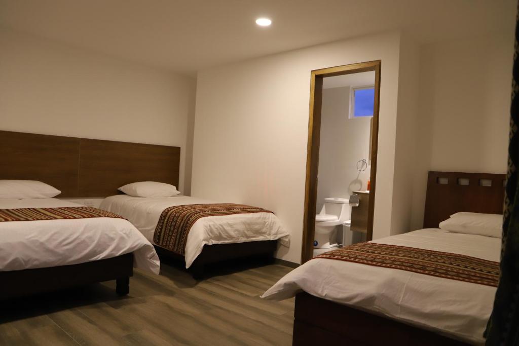 Postel nebo postele na pokoji v ubytování Hotel El Geranio