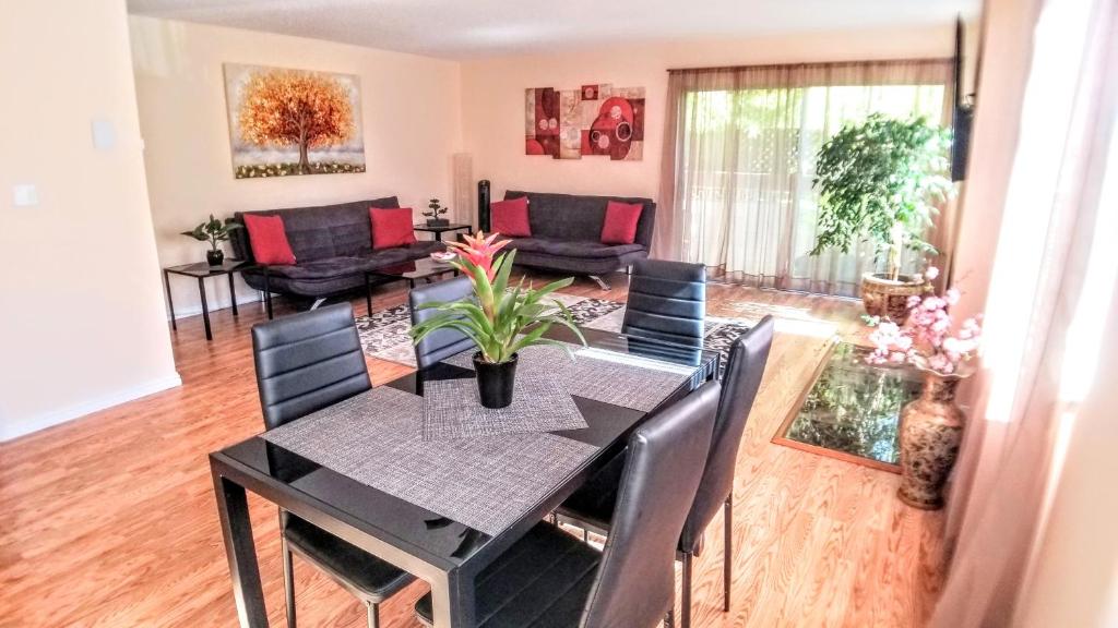 a dining room with a black table and chairs at Double Suite Santa Monica - Free Parking in Santa Monica