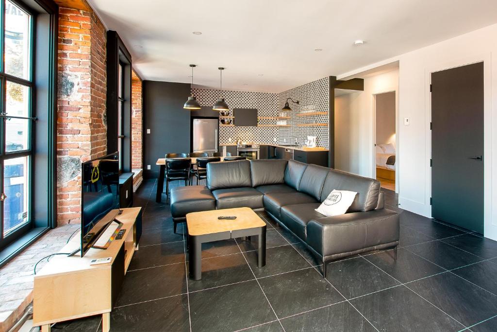 a living room with a couch and a table at Les Lofts St-Vallier - Par Les Lofts Vieux Québec in Quebec City