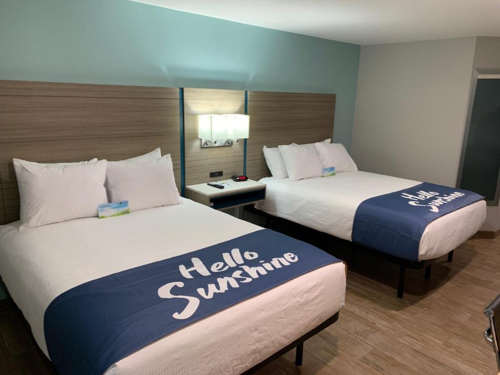 two beds in a hotel room with two at Days Inn by Wyndham Rockport Texas in Rockport