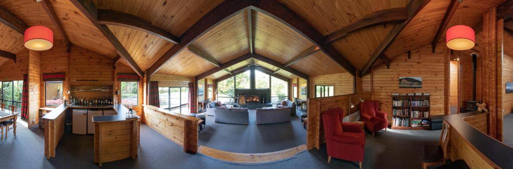 an inside view of a wooden cabin with a living room at Westwood Lodge in Franz Josef