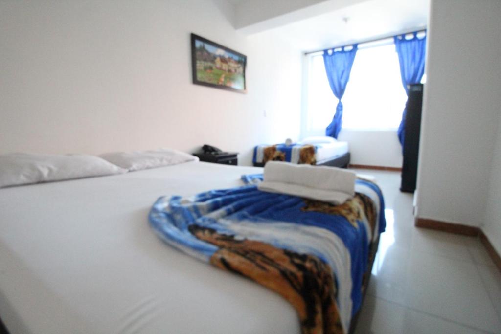 Postel nebo postele na pokoji v ubytování HOTEL MANAGER OBELISK