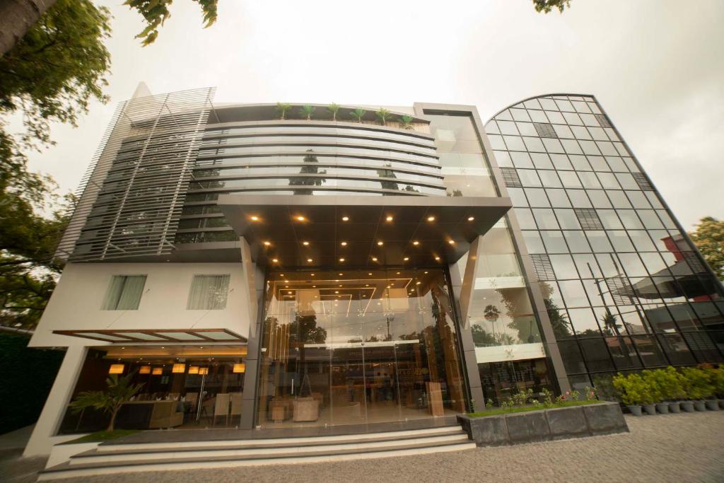 a large building with a lot of windows at HOTEL SAVITHRI in Attingal