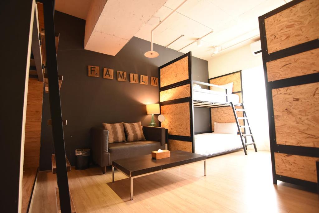 a living room with a couch and a bunk bed at NK Hostel in Taipei