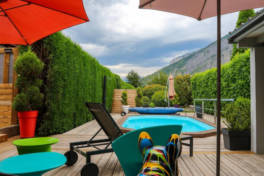 a dog laying on a chair next to a pool at Chambre D'hôtes Chez Dom in Saint-Jean-de-Maurienne