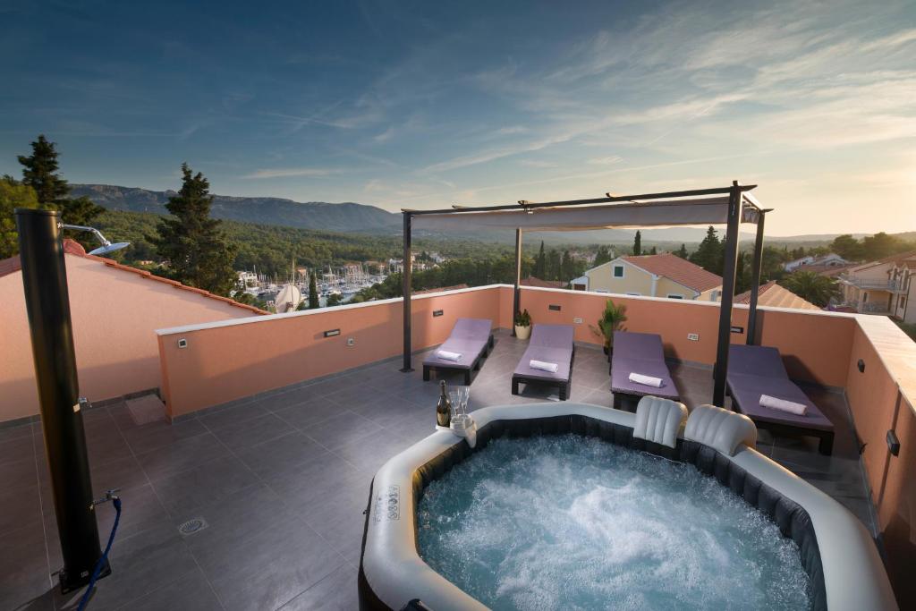 a hot tub on the roof of a house at Guest House Marinna in Vrboska