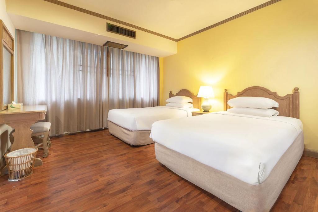 Rúm í herbergi á Regent - Chalet, Hua Hin