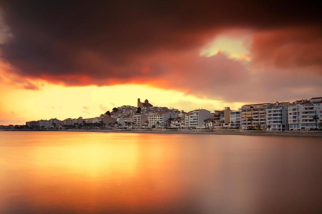 a view of a city from the water at sunset at Ocean Lounge in Altea