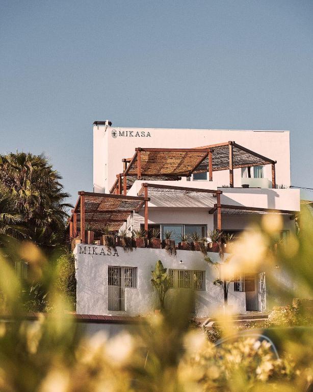 a white building with trees in front of it at Mikasa Ibiza Boutique Hotel ADULTS ONLY in Ibiza Town