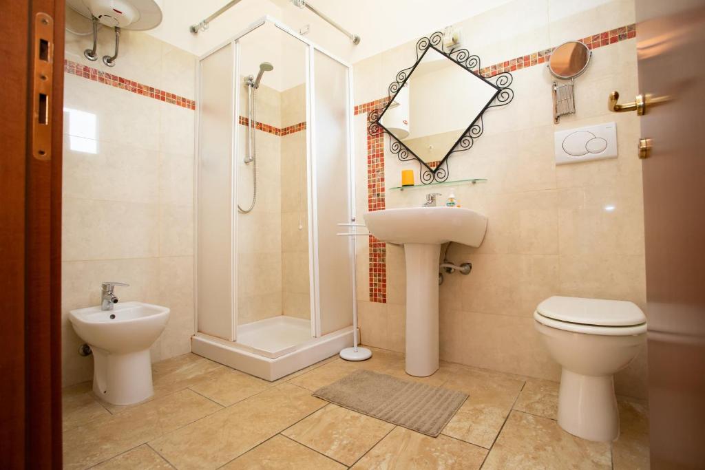 a bathroom with a toilet and a sink and a shower at Villa Liburnia in Livorno
