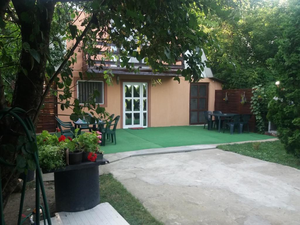 a patio of a house with a green lawn at Casa Stela in Iaşi