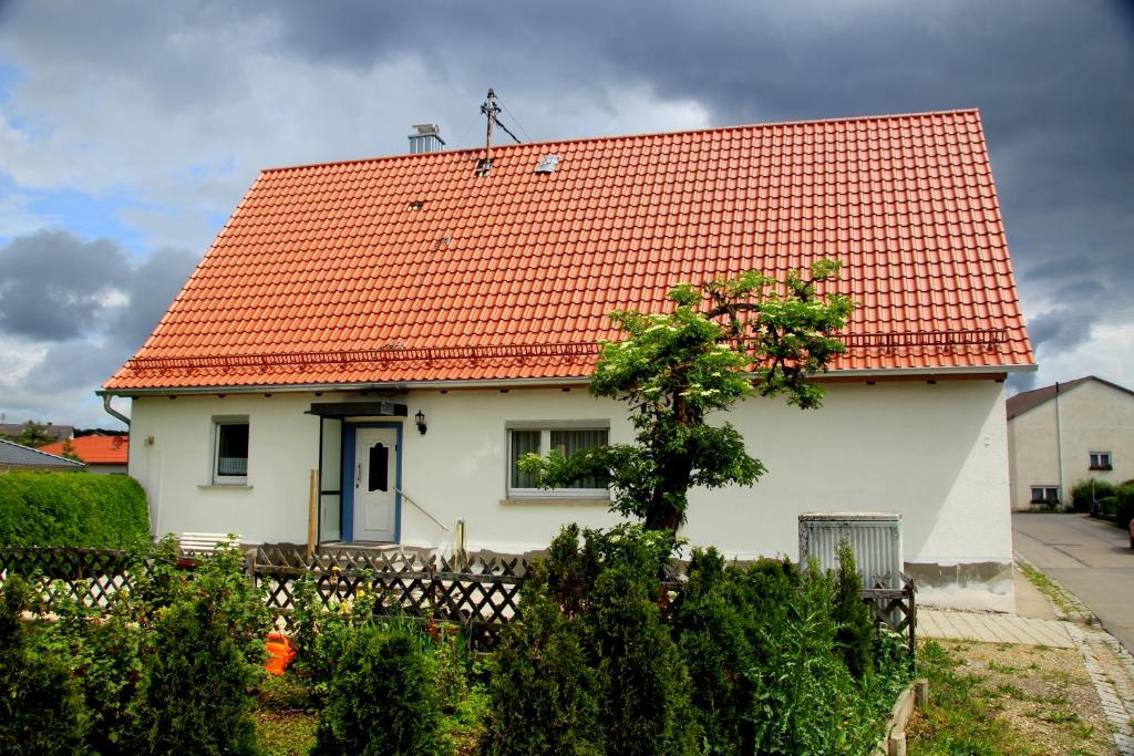 a white house with an orange tile roof at Marienhof in Leibertingen