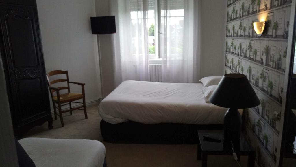 Postel nebo postele na pokoji v ubytování Hôtel Patton